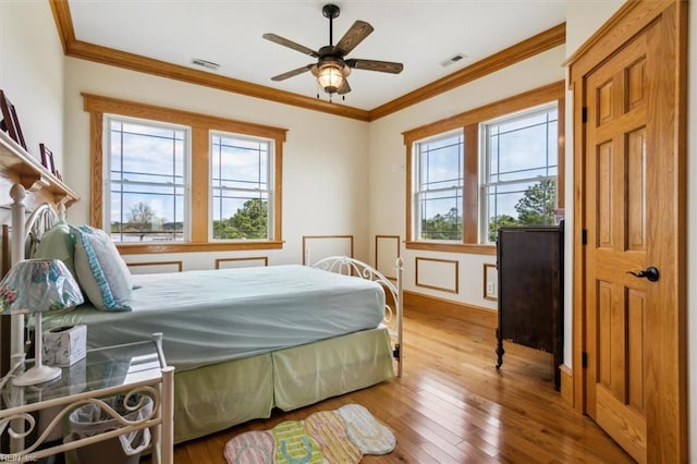 9954 Bonniville Rd, Hayes, VA 23072 - bedroom with crown molding, multiple windows, visible vents, and wood finished floors