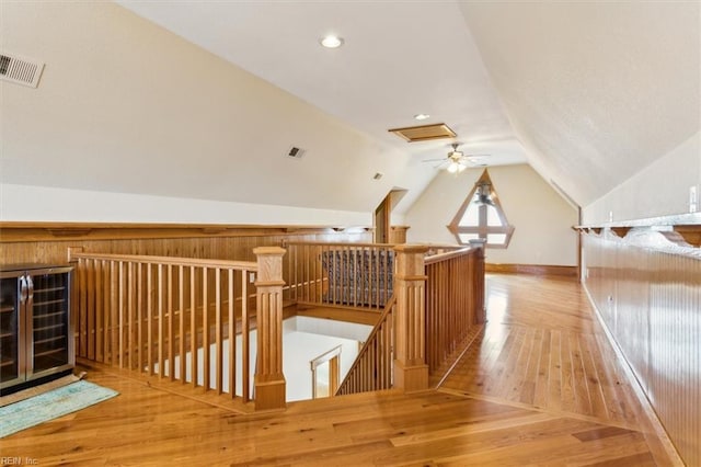 9954 Bonniville Rd, Hayes, VA 23072 - bonus room featuring wine cooler, visible vents, vaulted ceiling, wood finished floors, and baseboards