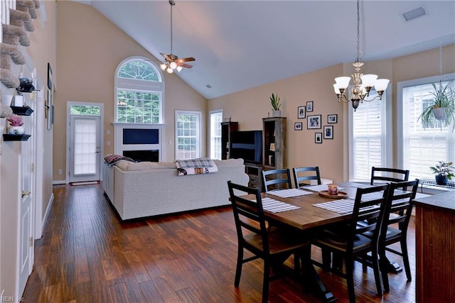 dining room featuring high vaulted ceiling, dark wood-style flooring, visible vents, and ceiling fan with notable chandelier