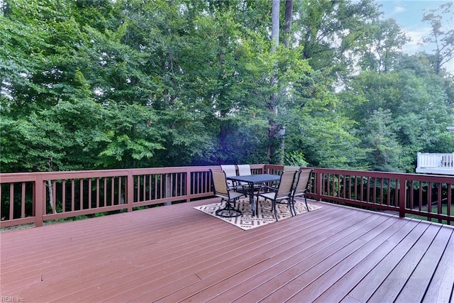 wooden terrace featuring outdoor dining space