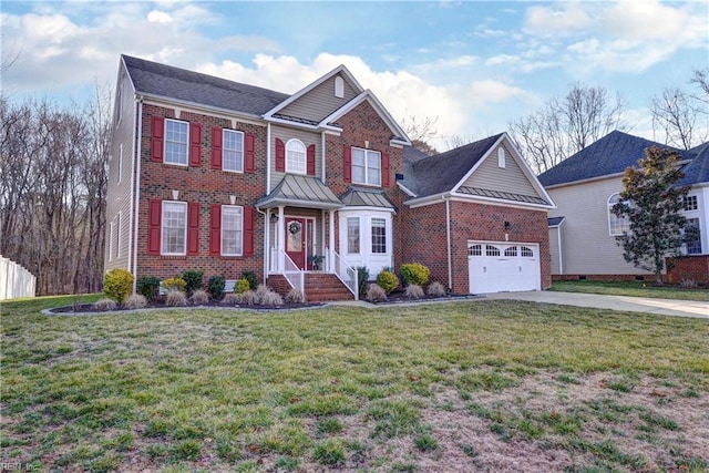 view of front facade featuring concrete driveway, brick siding, a front lawn, and a standing seam roof