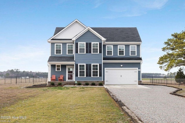 view of front of property with a garage, gravel driveway, fence, and a front lawn