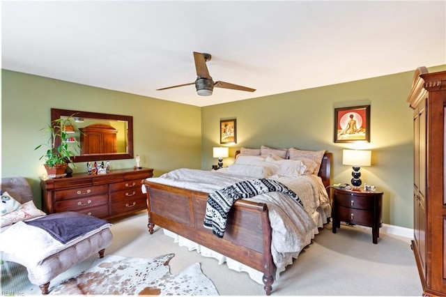 bedroom featuring light carpet, ceiling fan, and baseboards