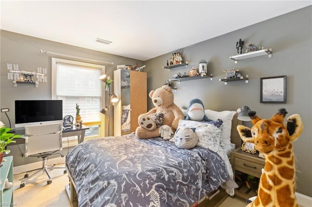 carpeted bedroom with visible vents and baseboards