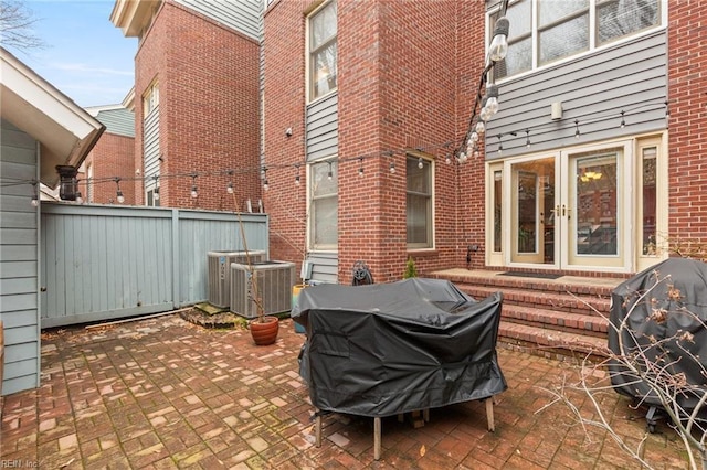 view of patio featuring central air condition unit, fence, grilling area, and french doors