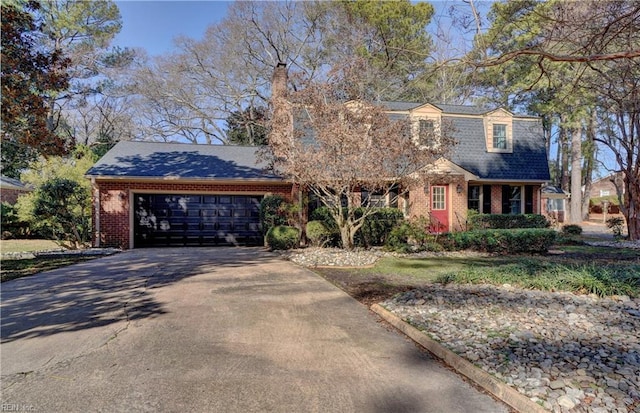 view of front of home featuring a garage, a shingled roof, concrete driveway, a chimney, and brick siding