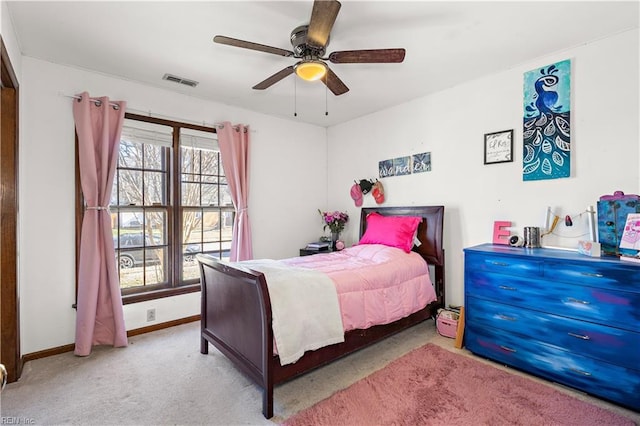 bedroom with light carpet, ceiling fan, visible vents, and baseboards