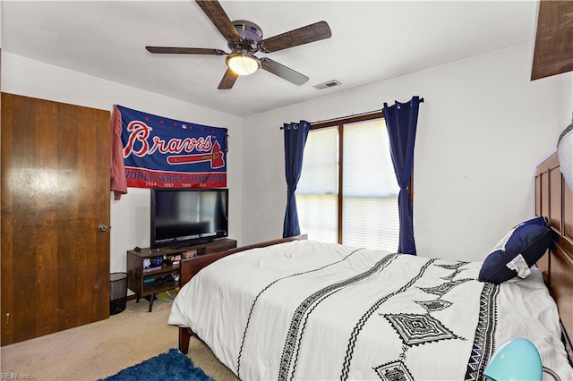 carpeted bedroom featuring visible vents and a ceiling fan