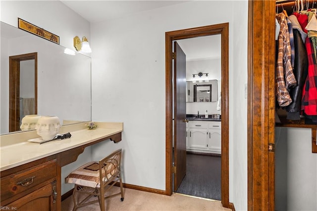 bathroom with vanity and baseboards