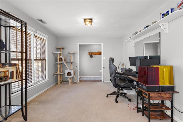 home office with light colored carpet, visible vents, and baseboards