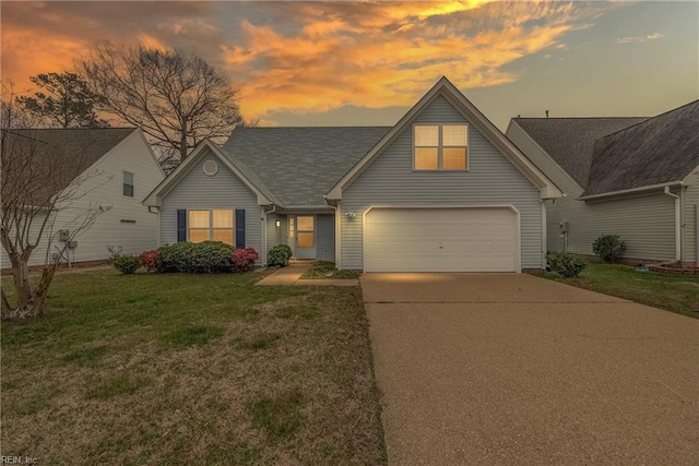 traditional home with driveway, a lawn, and an attached garage