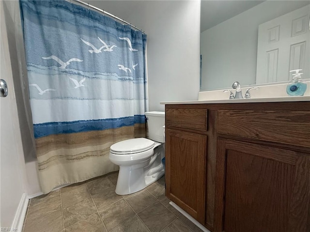 full bathroom featuring toilet, tile patterned floors, and vanity