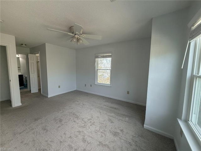 unfurnished bedroom with a ceiling fan, a textured ceiling, baseboards, and carpet flooring