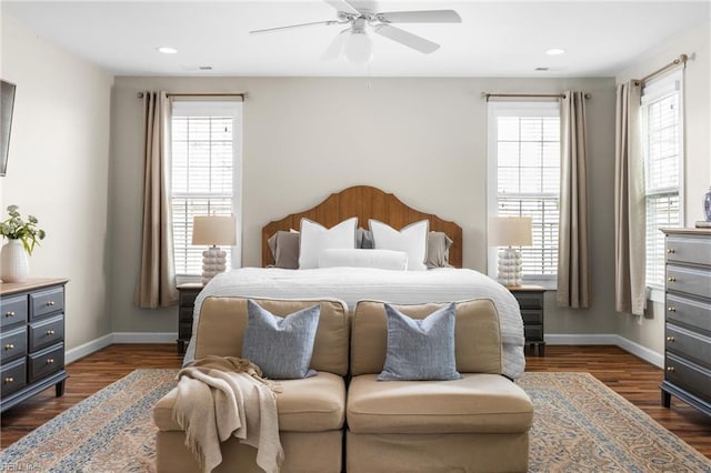 bedroom featuring dark wood-style floors, multiple windows, and baseboards