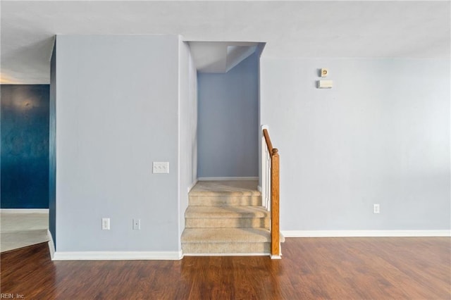 stairs featuring baseboards and wood finished floors