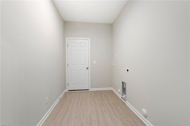 laundry area with light wood-style floors, laundry area, electric dryer hookup, and baseboards