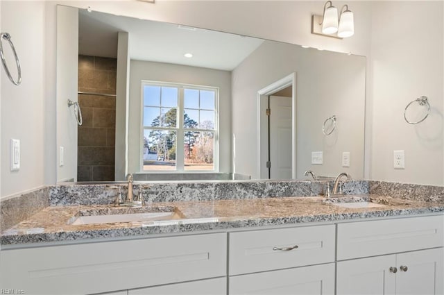 full bath with double vanity and a sink