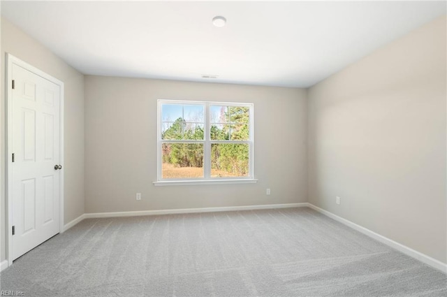 carpeted spare room with baseboards