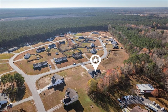 bird's eye view featuring a wooded view