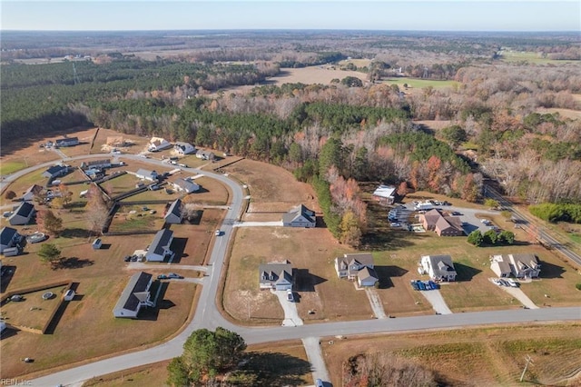 bird's eye view with a wooded view