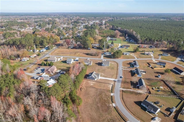 drone / aerial view with a wooded view