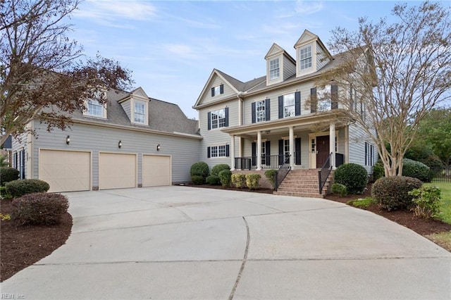 view of front of house with a porch, driveway, and an attached garage