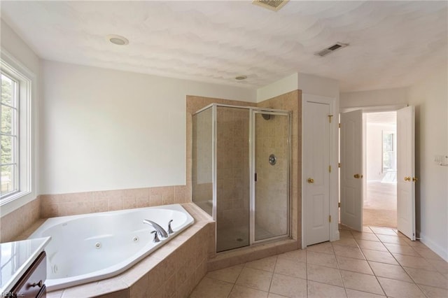 bathroom with a tub with jets, a stall shower, visible vents, and tile patterned floors