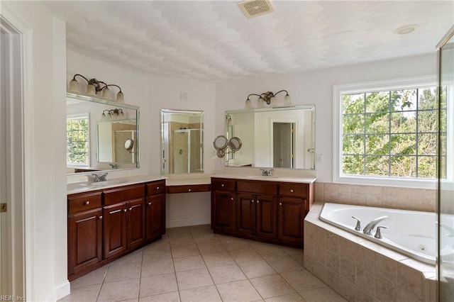 full bathroom with a jetted tub, a stall shower, visible vents, and a wealth of natural light