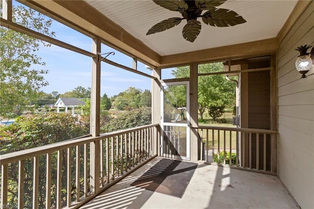 unfurnished sunroom featuring a ceiling fan