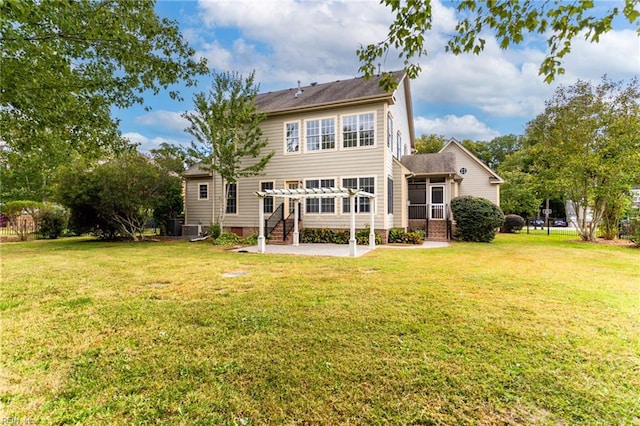 rear view of property with a yard, central AC, a patio, and a pergola