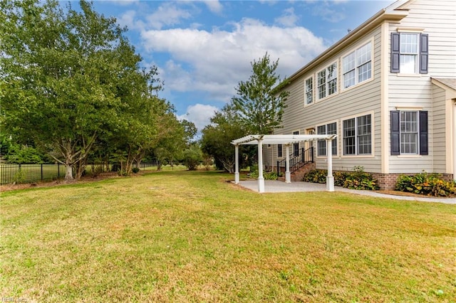 view of yard with a patio area, fence, and a pergola