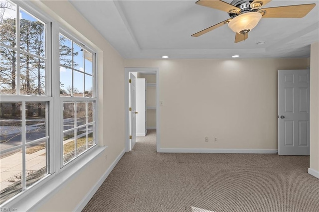 spare room featuring light carpet, ceiling fan, baseboards, and recessed lighting