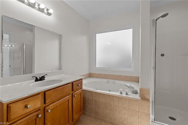 bathroom with a whirlpool tub, a shower stall, tile patterned flooring, and vanity