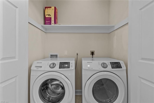 clothes washing area featuring laundry area and washing machine and clothes dryer