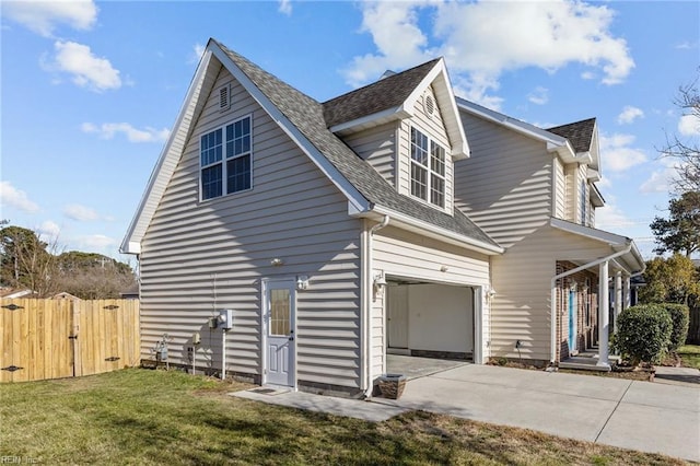 view of home's exterior featuring a garage, fence, concrete driveway, a lawn, and roof with shingles