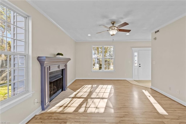 living room with a fireplace with flush hearth, light wood-style flooring, and baseboards