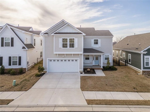 traditional-style home with a porch, board and batten siding, fence, a garage, and driveway