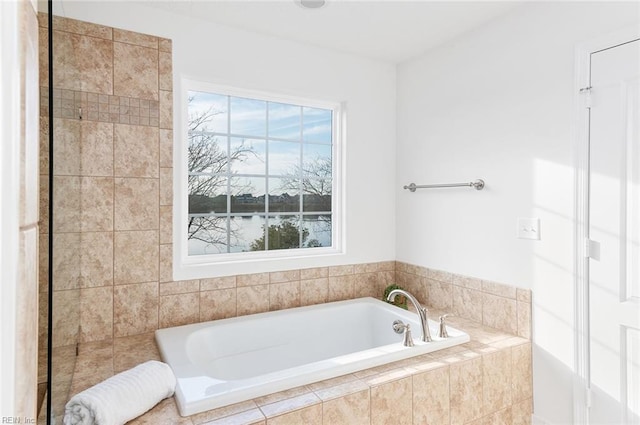 full bathroom featuring a healthy amount of sunlight and a garden tub