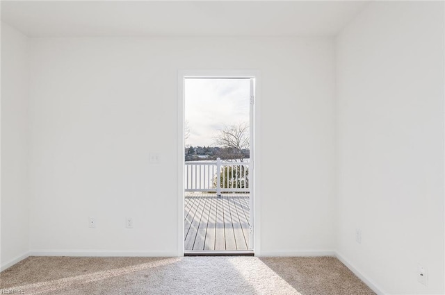 empty room featuring carpet flooring and baseboards