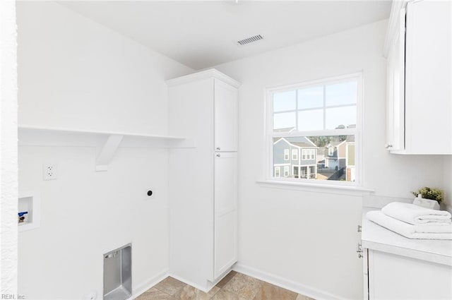 washroom featuring cabinet space, hookup for a washing machine, electric dryer hookup, and baseboards