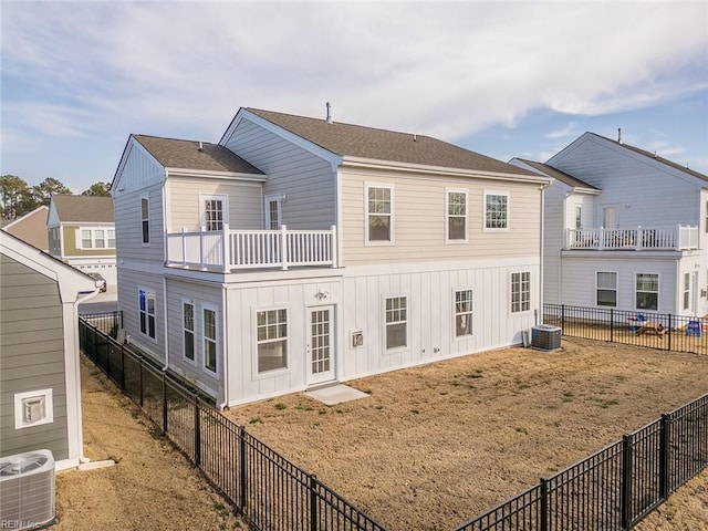 back of property featuring board and batten siding, a fenced backyard, a shingled roof, and central AC unit