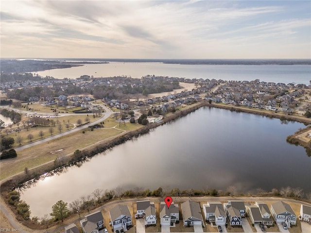 drone / aerial view with a water view and a residential view