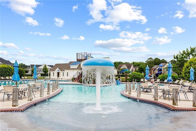 community pool with a patio area