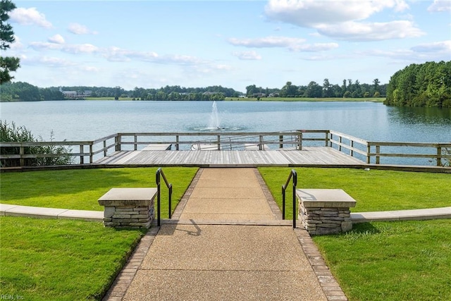 exterior space with a water view and a yard