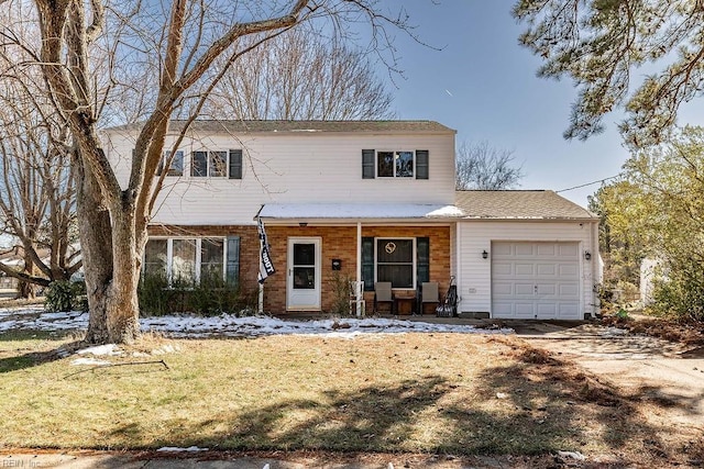 traditional-style house featuring brick siding, covered porch, an attached garage, driveway, and a front lawn