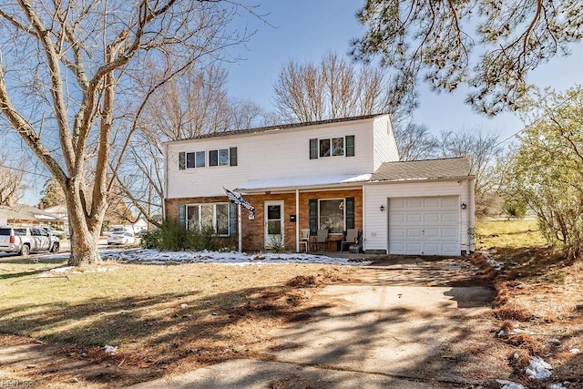 view of front of property with a garage, covered porch, brick siding, and dirt driveway