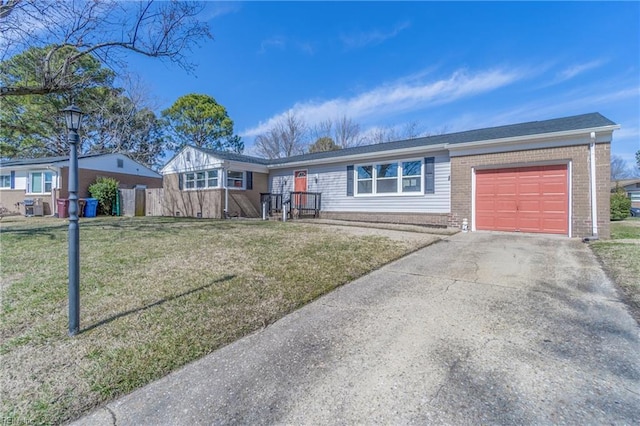 ranch-style house featuring a front yard, brick siding, driveway, and an attached garage