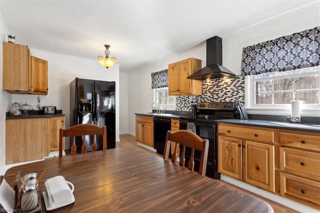 kitchen featuring wall chimney exhaust hood, dark countertops, decorative backsplash, a sink, and black appliances
