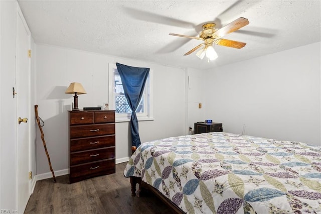 bedroom featuring a textured ceiling, ceiling fan, dark wood finished floors, and baseboards