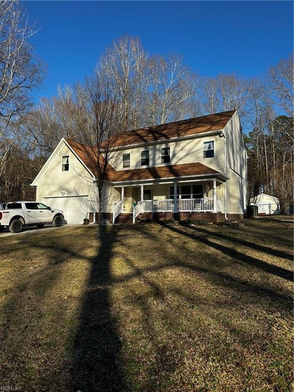 view of front of property with covered porch and a front yard